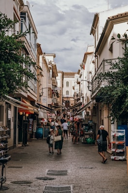 A narrow cobblestone street in Tirana bustling with local life.