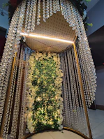 Statement floral piece suspended above a reception area, blending natural forms with subtle elegance.