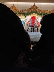 An artistic depiction of a couple under divine blessings with temple motifs and soft golden highlights.