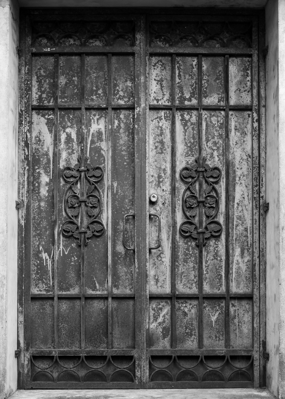 a black and white photo of two doors