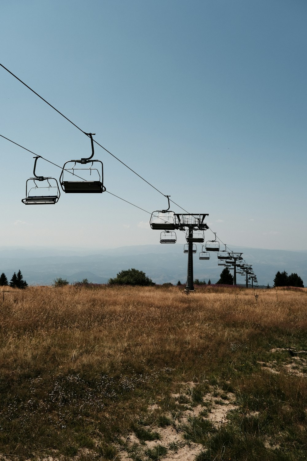 a couple of gondolas sitting on top of a grass covered field