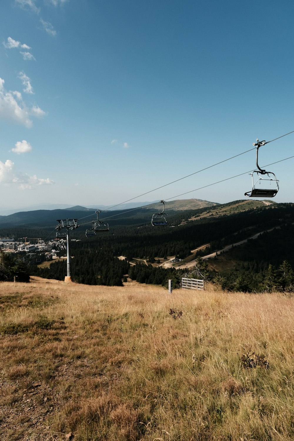 a view of a hill with a ski lift in the background