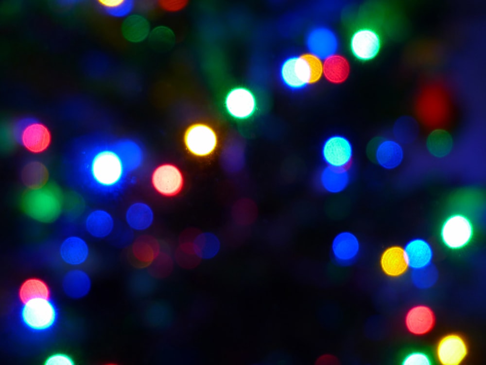 a blurry photo of a christmas tree with multicolored lights
