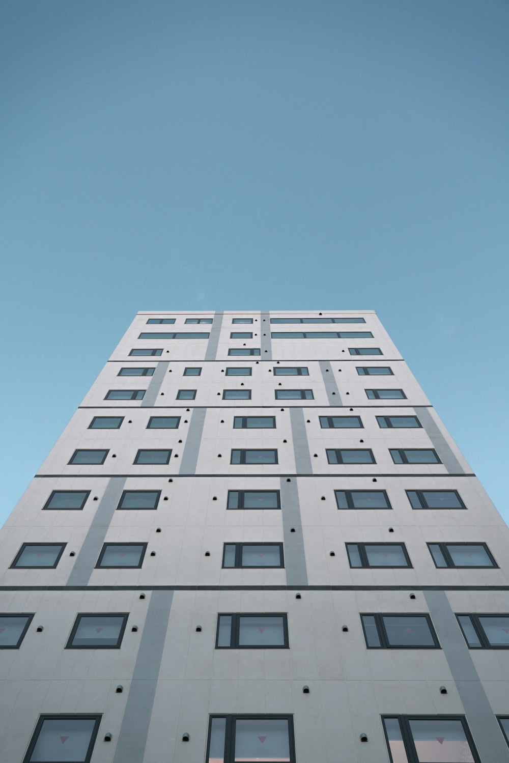 a tall white building with lots of windows
