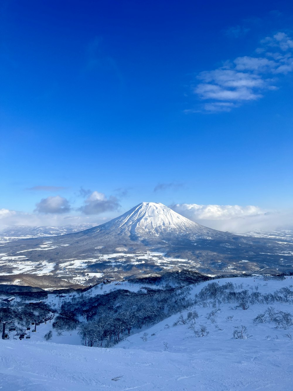 a snow covered mountain under a blue sky