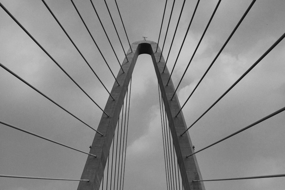 a black and white photo of a very tall bridge