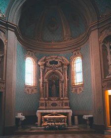 a church with a large alter and stained glass windows