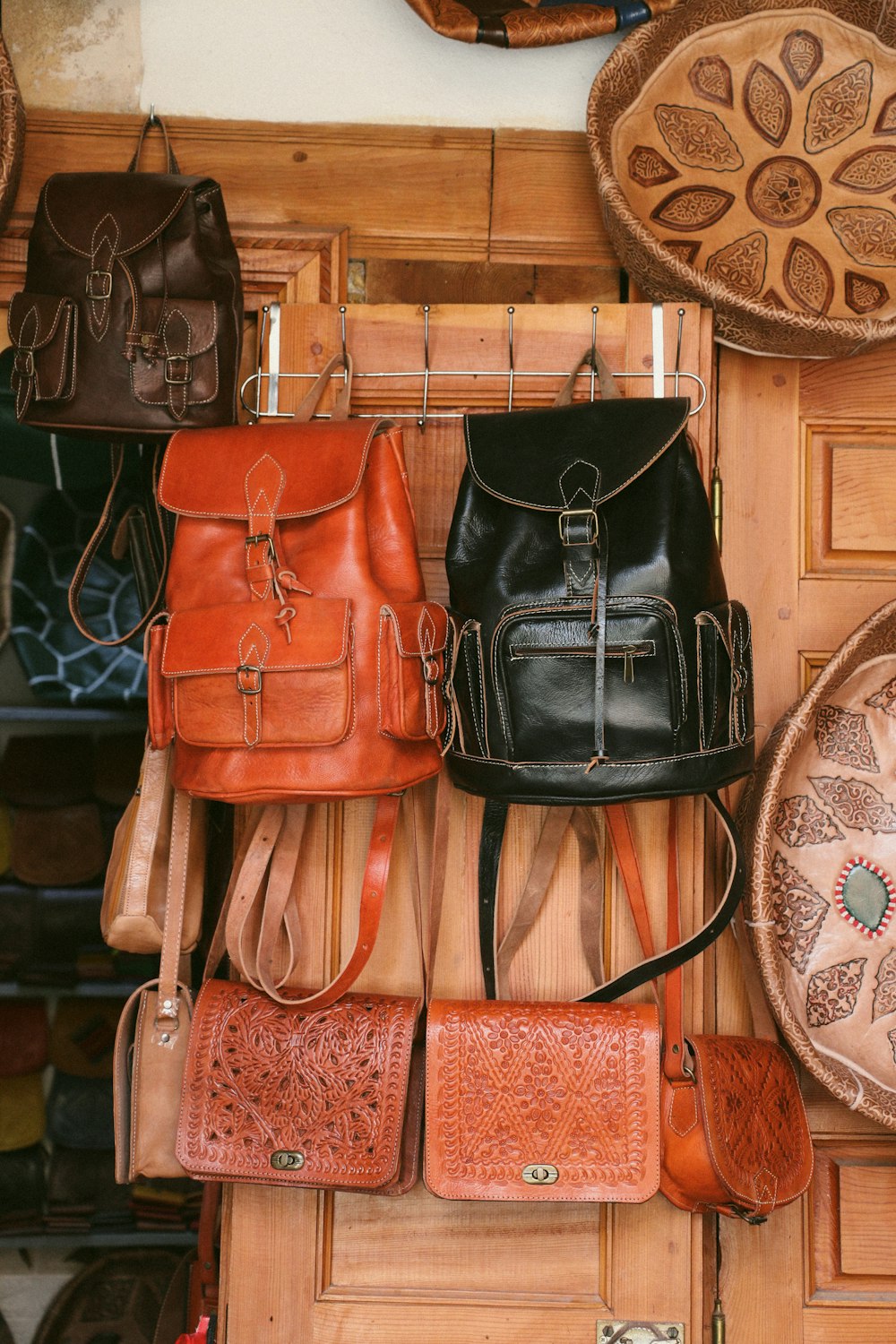 a bunch of purses hanging on a wall