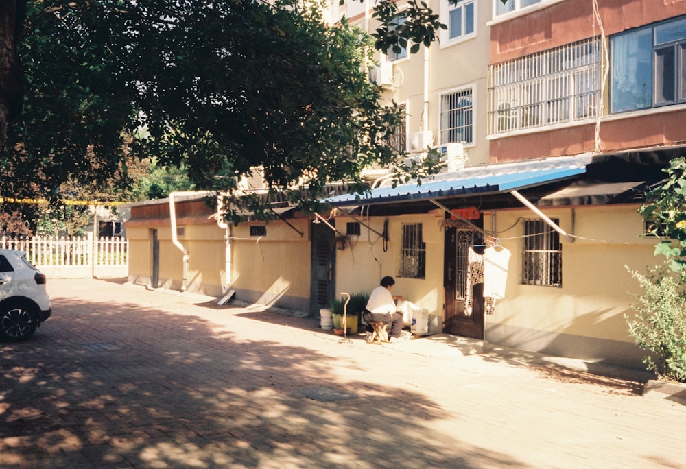 a car parked on the side of a road next to a building