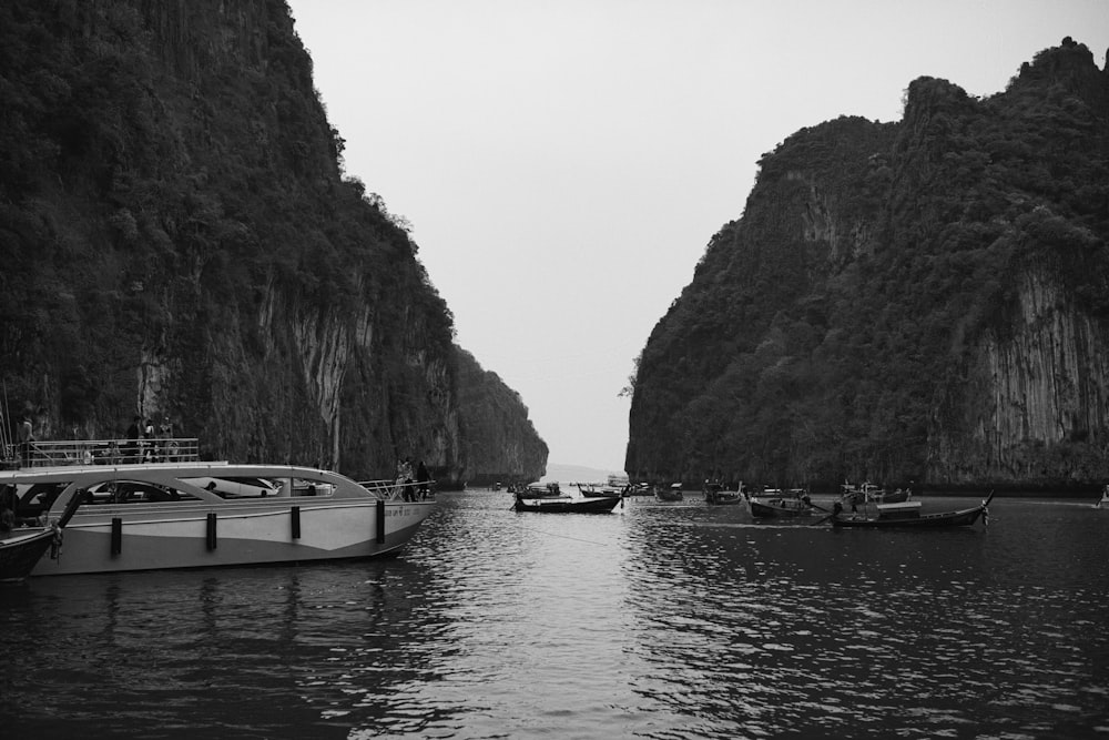 a black and white photo of boats in the water