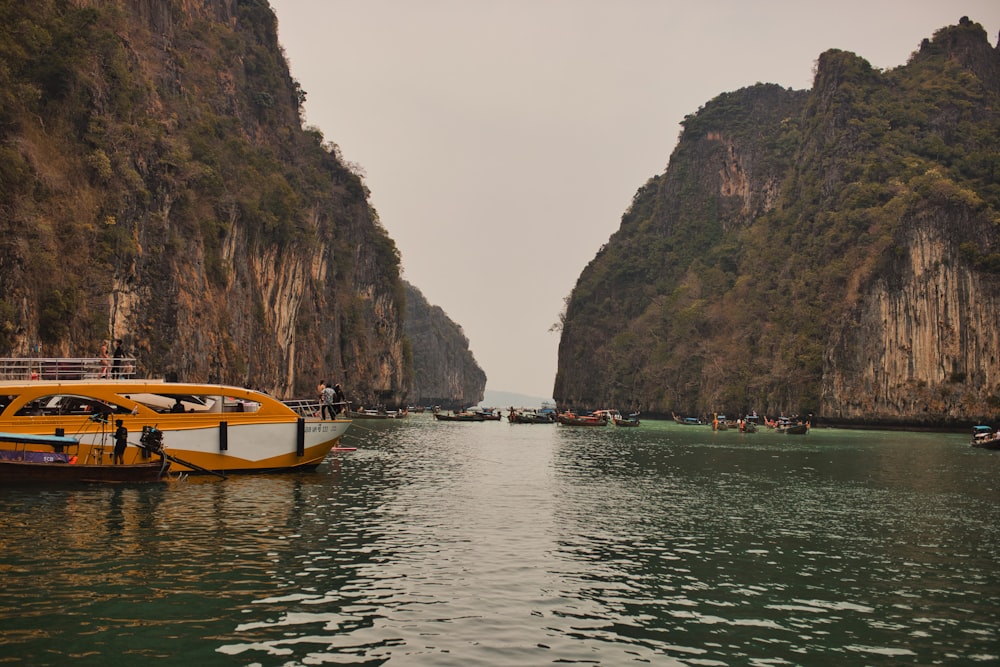 a yellow and white boat in a body of water