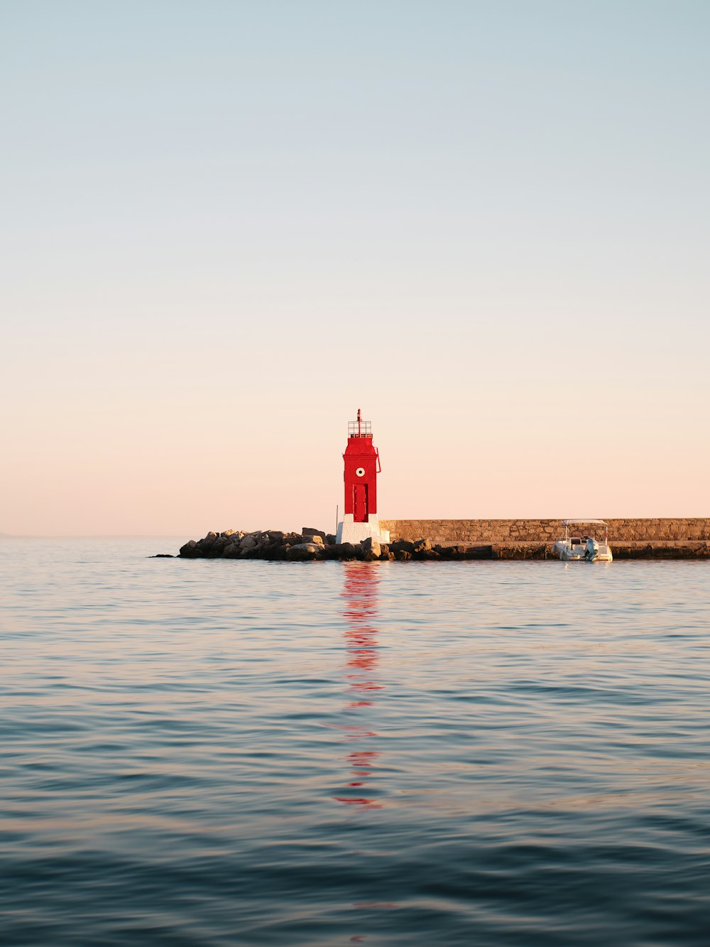 a light house sitting on top of a body of water