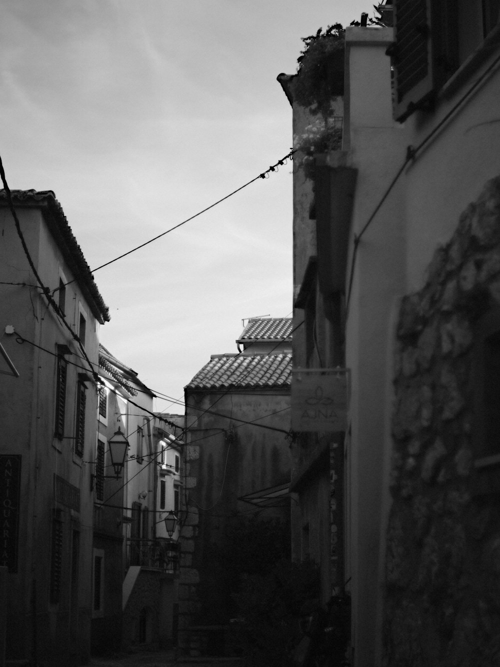 a black and white photo of an alley way