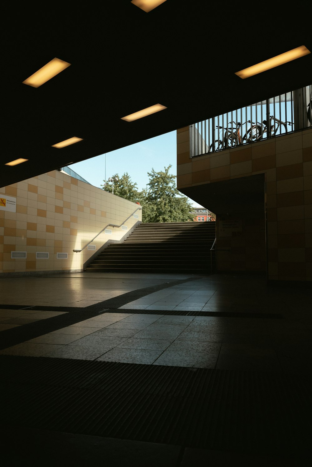 an empty room with a staircase and tiled walls