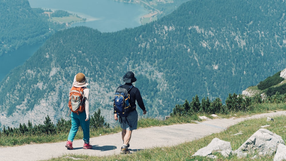 a couple of people that are walking down a hill