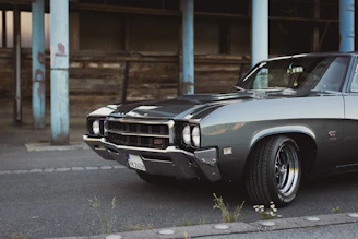 A sleek American muscle car parked in a sunny urban setting.
