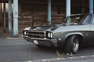 A sleek American muscle car parked in a sunny urban setting.