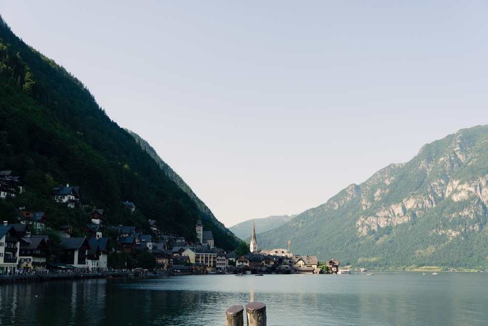 a body of water surrounded by mountains and houses