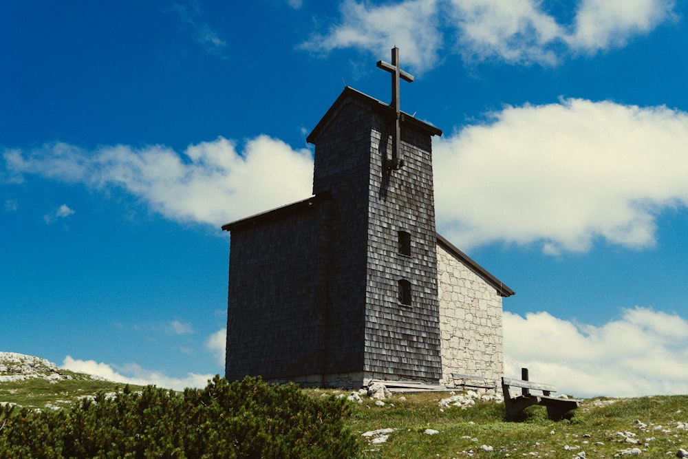 a small church with a cross on top of it