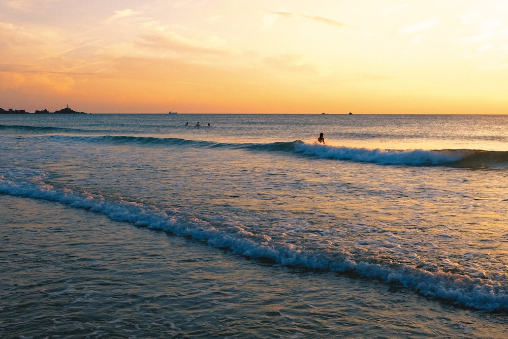 a person riding a surfboard on a wave in the ocean