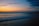 A serene beach at sunset with gentle waves.