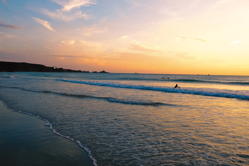 a person riding a surfboard on a wave in the ocean