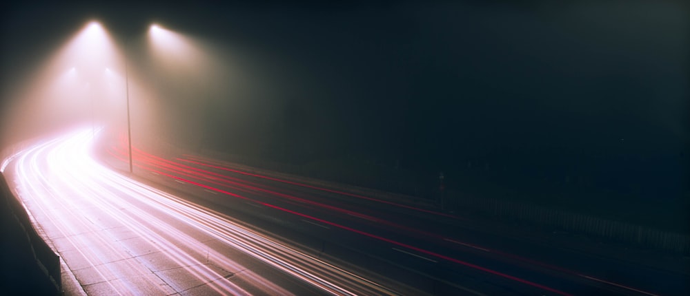 a long exposure photo of a highway at night