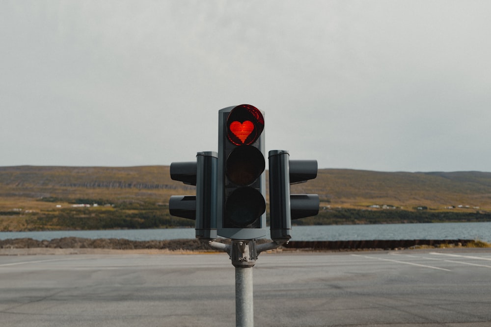 a traffic light with a red heart on it