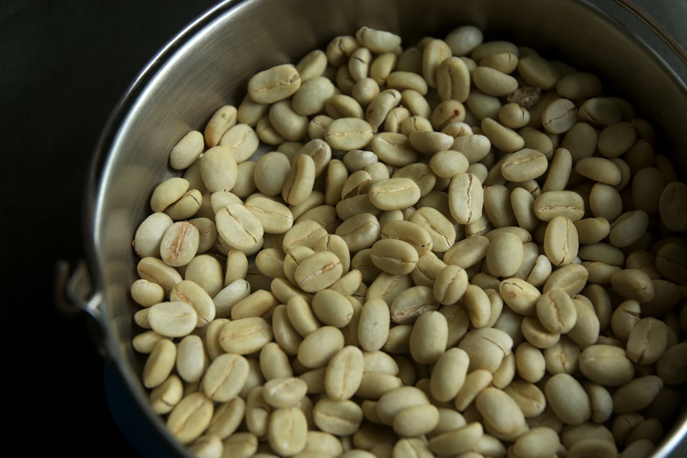 a metal pot filled with beans on top of a stove