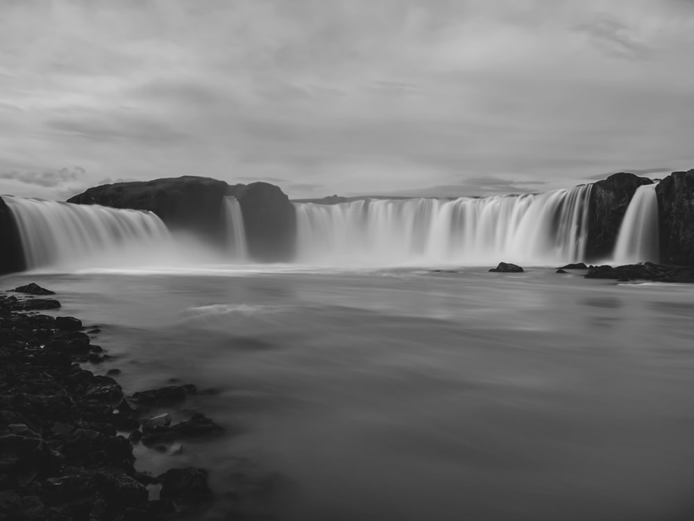 a black and white photo of a waterfall