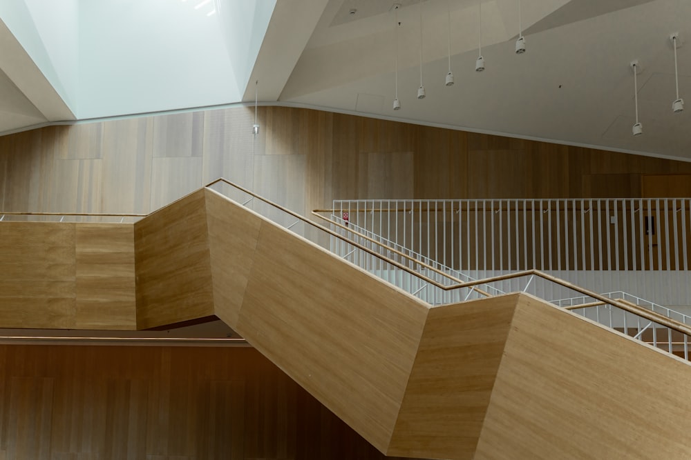 a wooden staircase in a building with a skylight