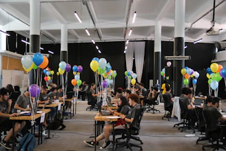A bright, spacious innovation lab filled with students experimenting with drones and AI devices.