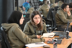 Students collaborating on a project with laptops open.