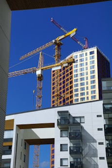 a building under construction with a crane in the background