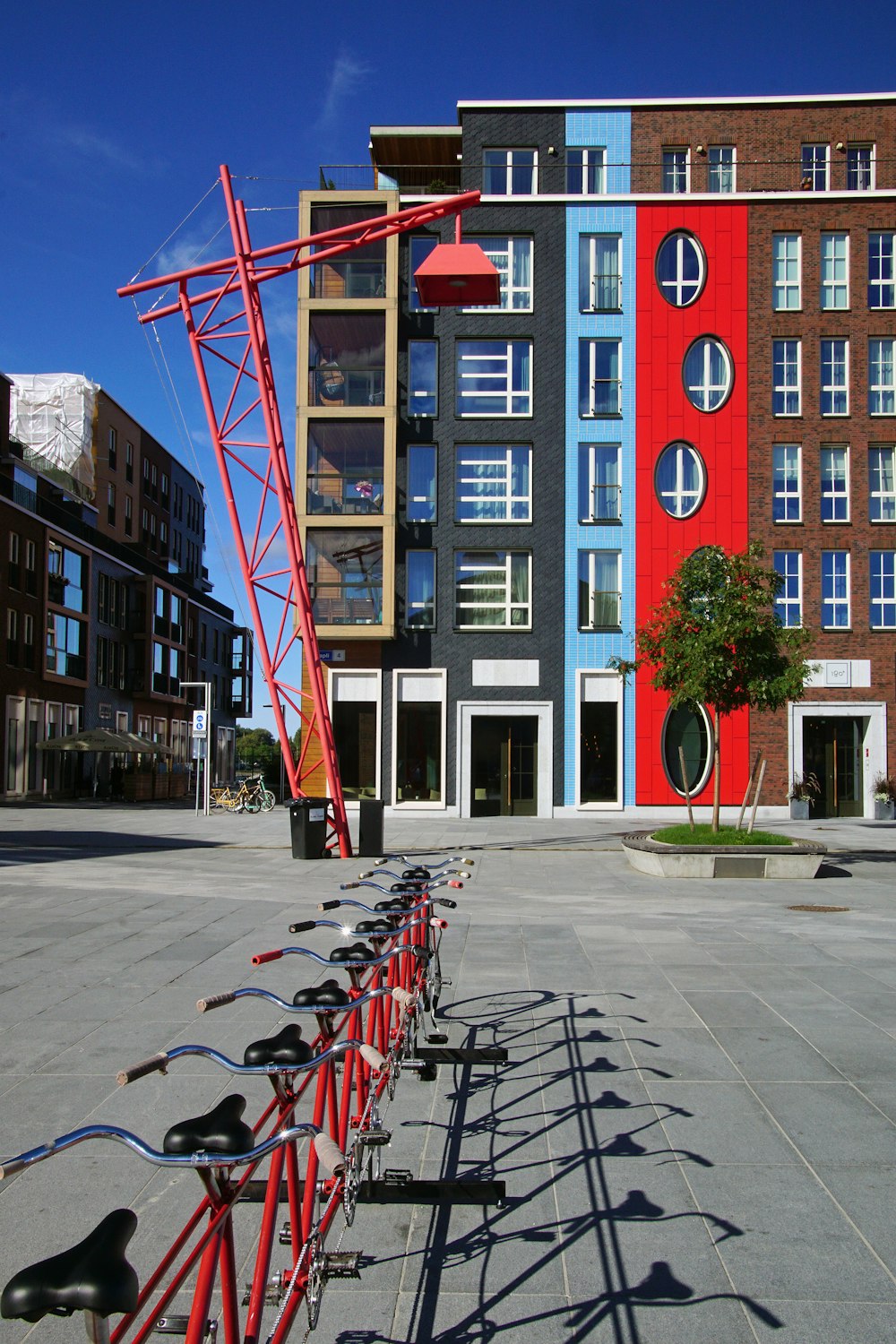 a row of bikes parked in front of a building