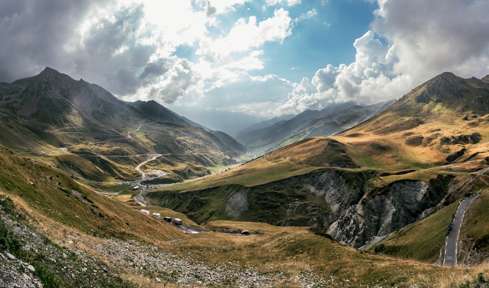 a scenic view of a valley with mountains in the background