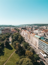 A cityscape with green rooftops and eco-friendly transport vehicles in motion.