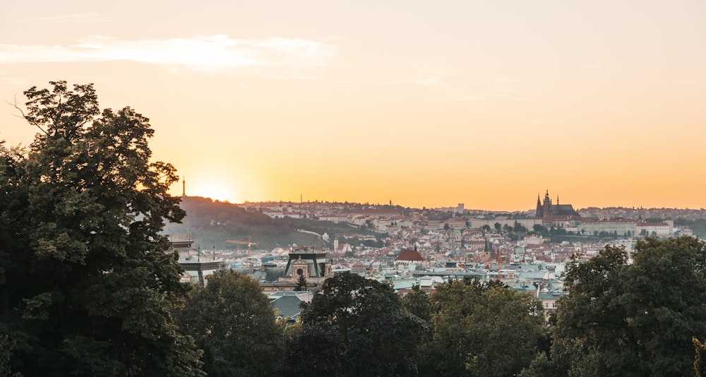 a view of a city from a hill at sunset