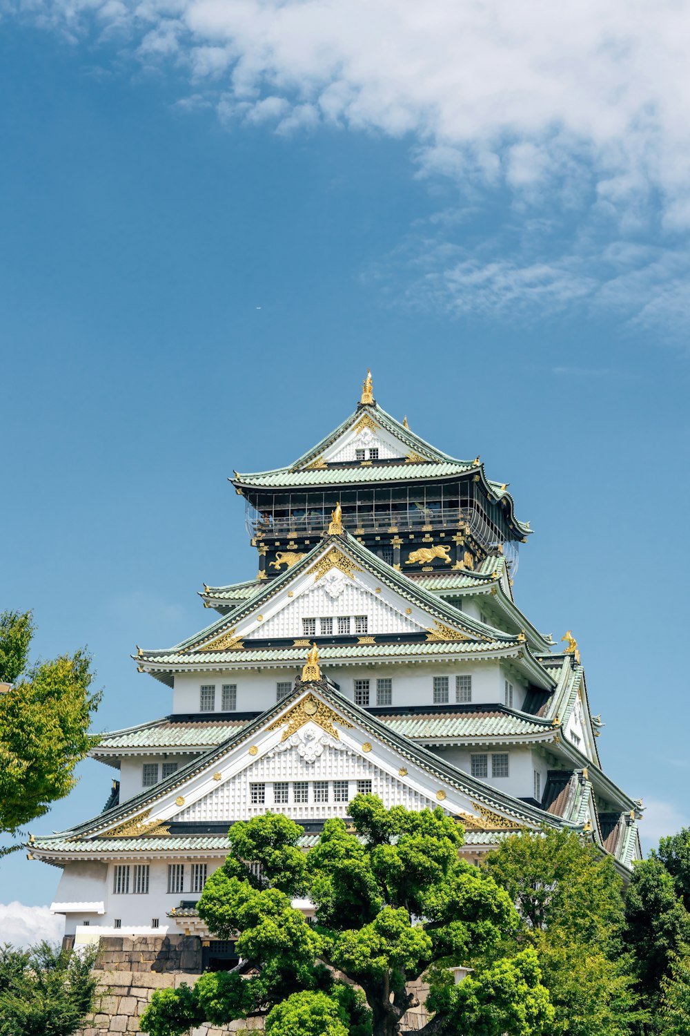 a tall white building with a golden roof