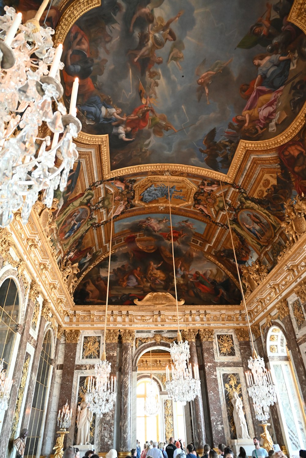 a room filled with lots of paintings and chandeliers