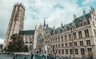 a large building with a tall tower next to a street