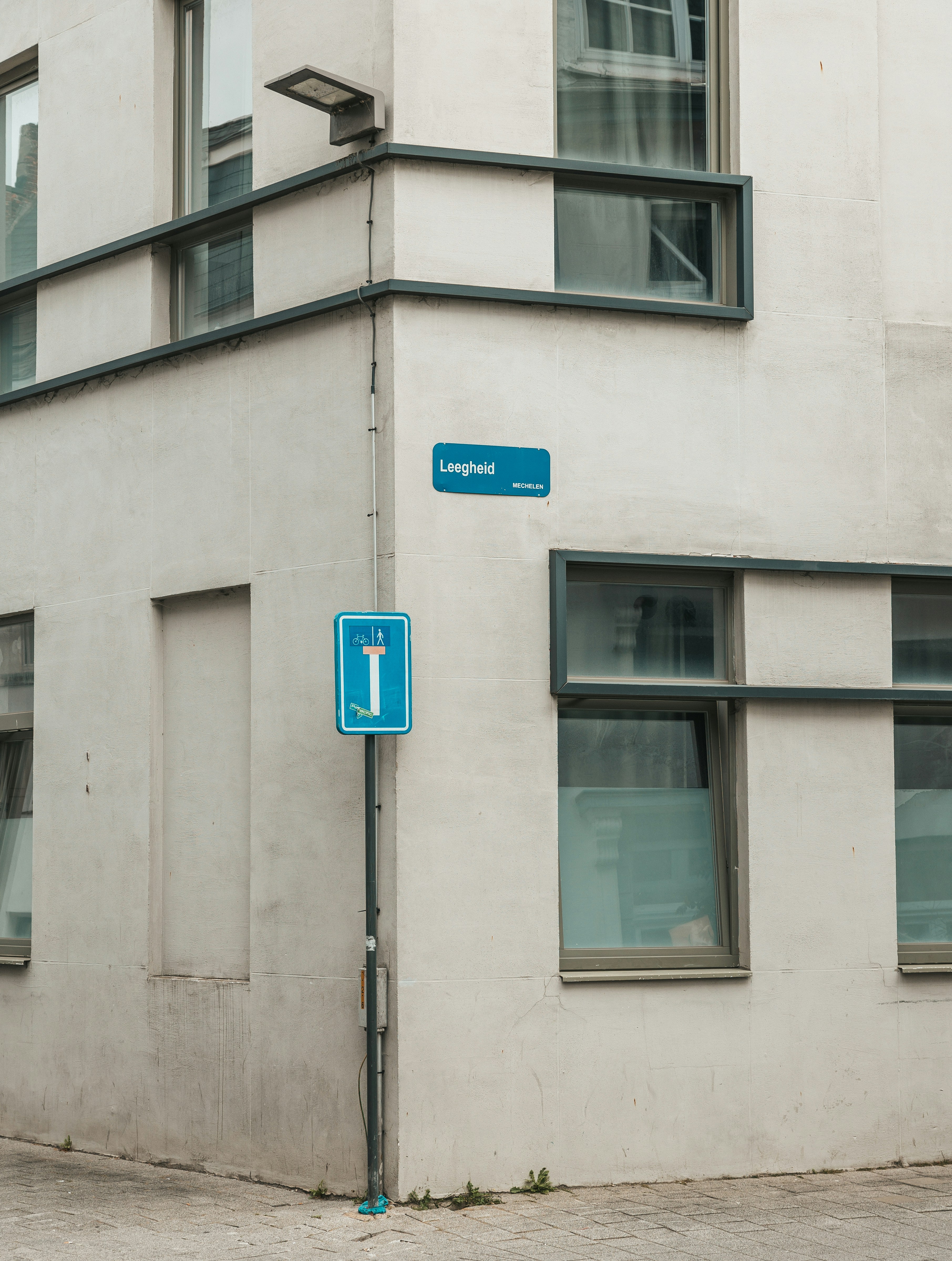 a street sign on a pole in front of a building
