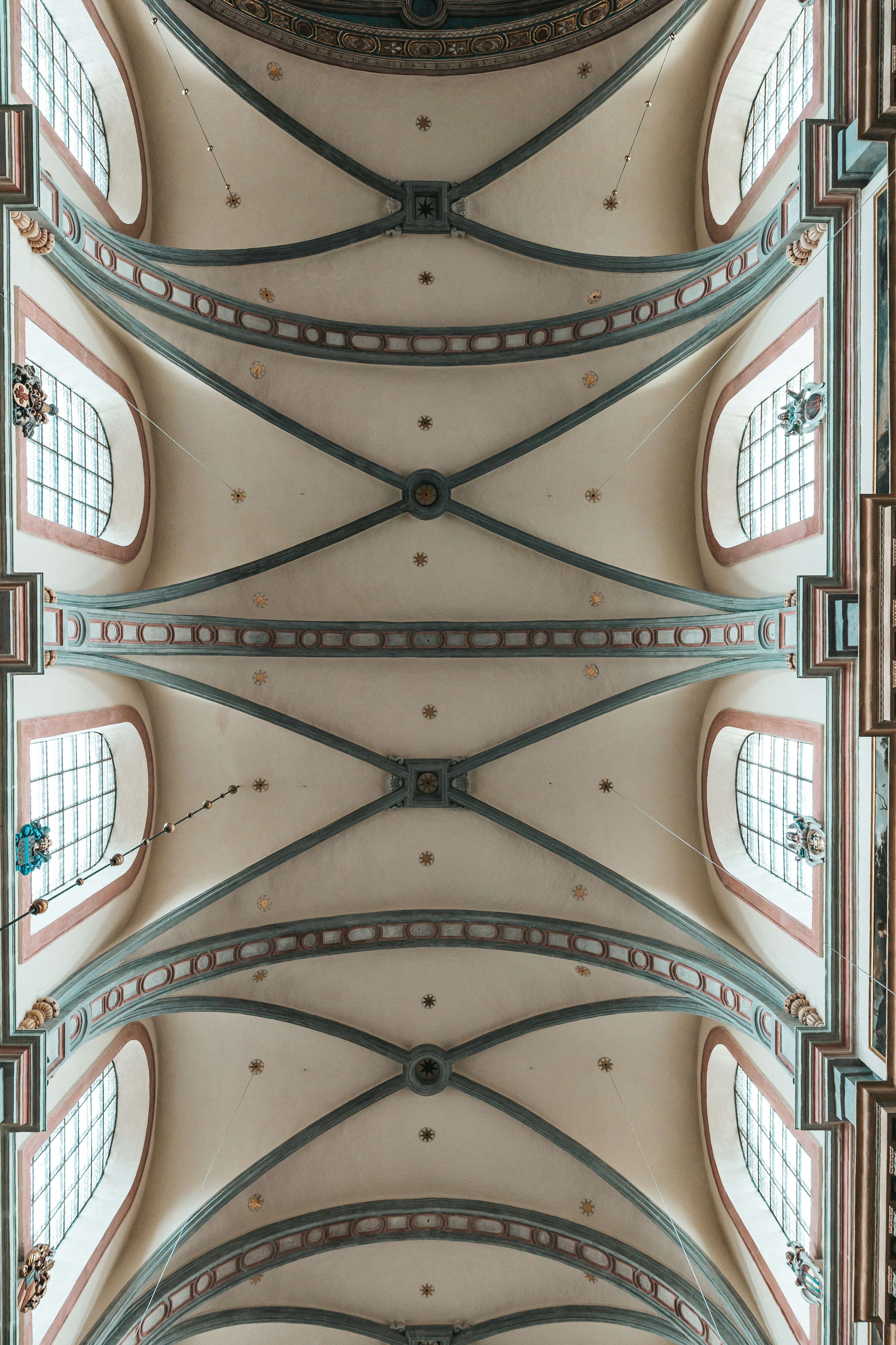 the ceiling of a large building with many windows