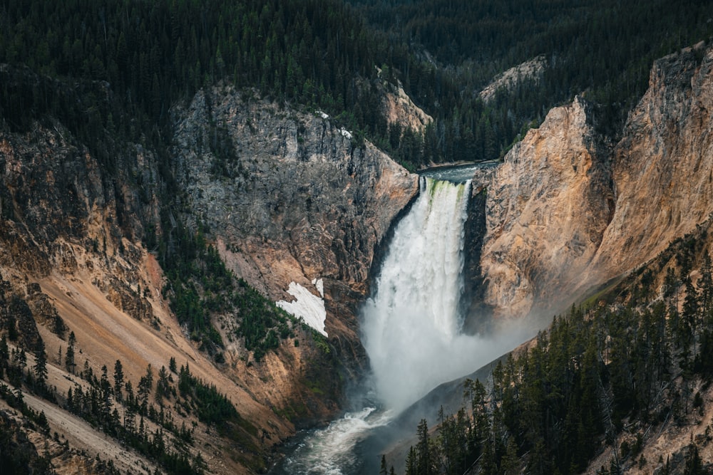 a view of a waterfall in the middle of a mountain