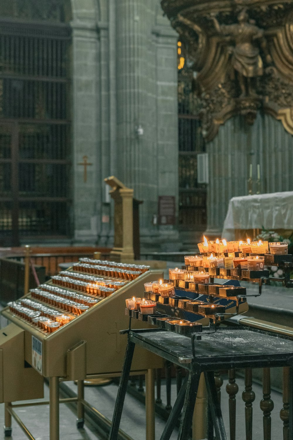 many candles are lit inside of a church