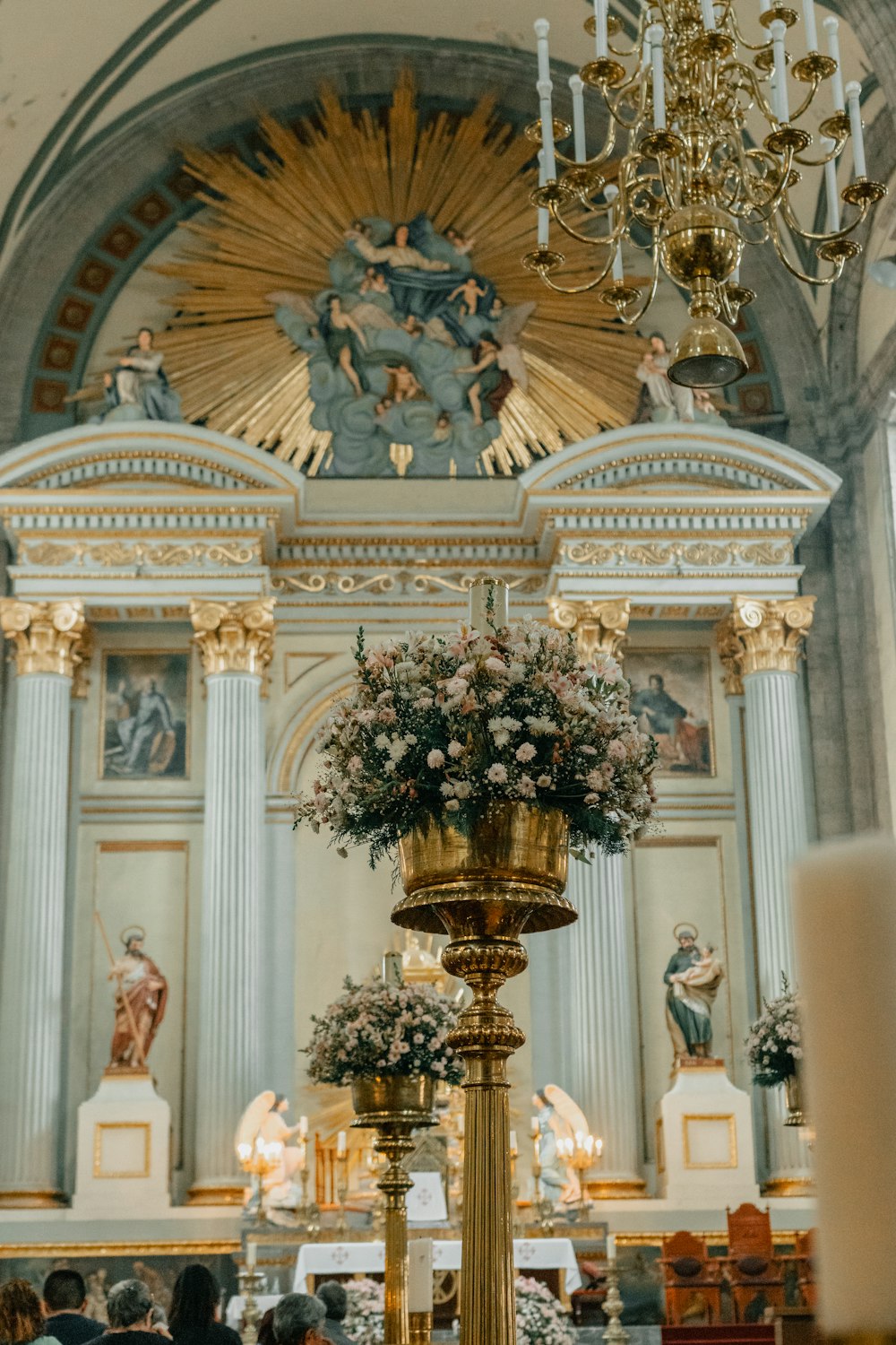 a church with a chandelier decorated with flowers