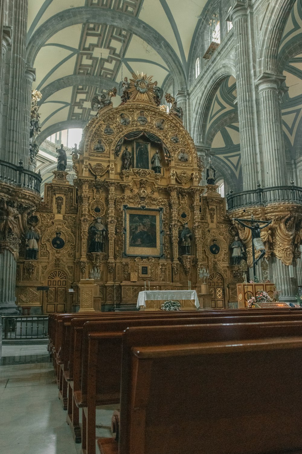 a church with a golden alter in the middle of it