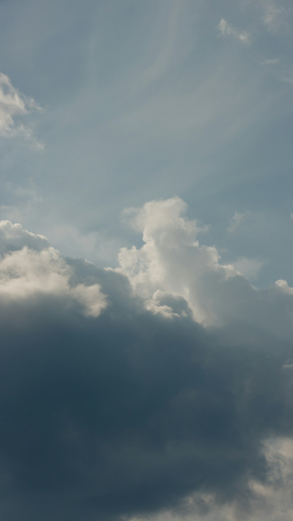 a plane flying in the sky with a lot of clouds