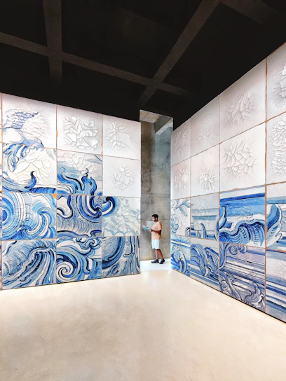 Minimalist gallery interior bathed in soft cloud-inspired blues and whites, with visitors engaging in lively discussion.