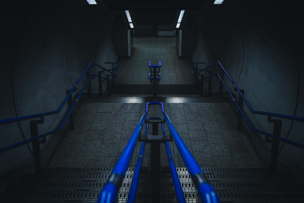 a set of blue pipes in a dark room